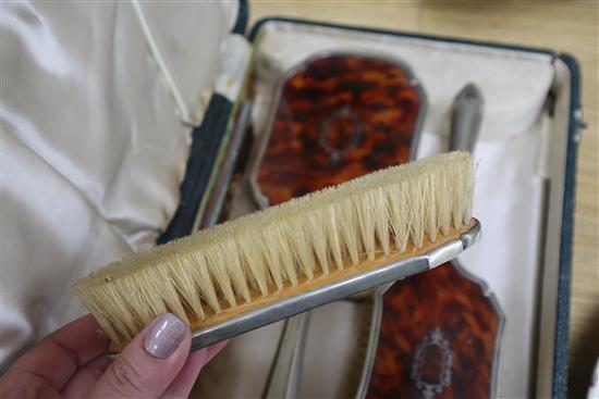 A cased plated and tortoiseshell brush set